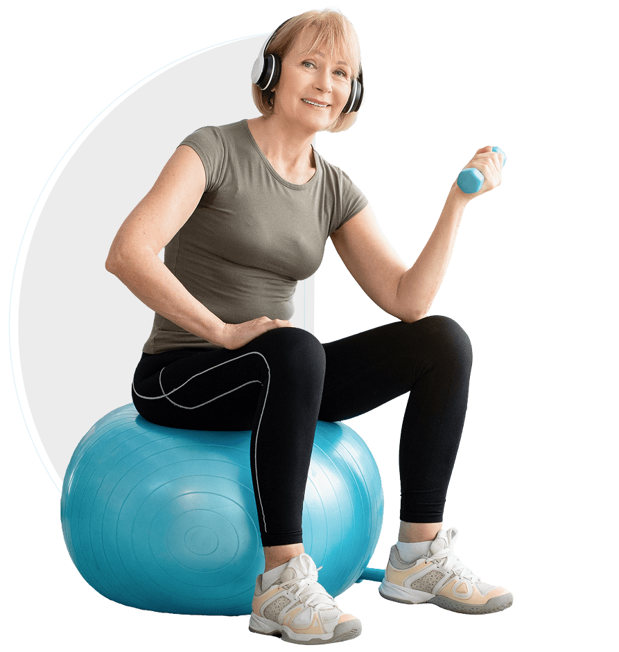 Woman exercising with dumbbell on stability ball.
